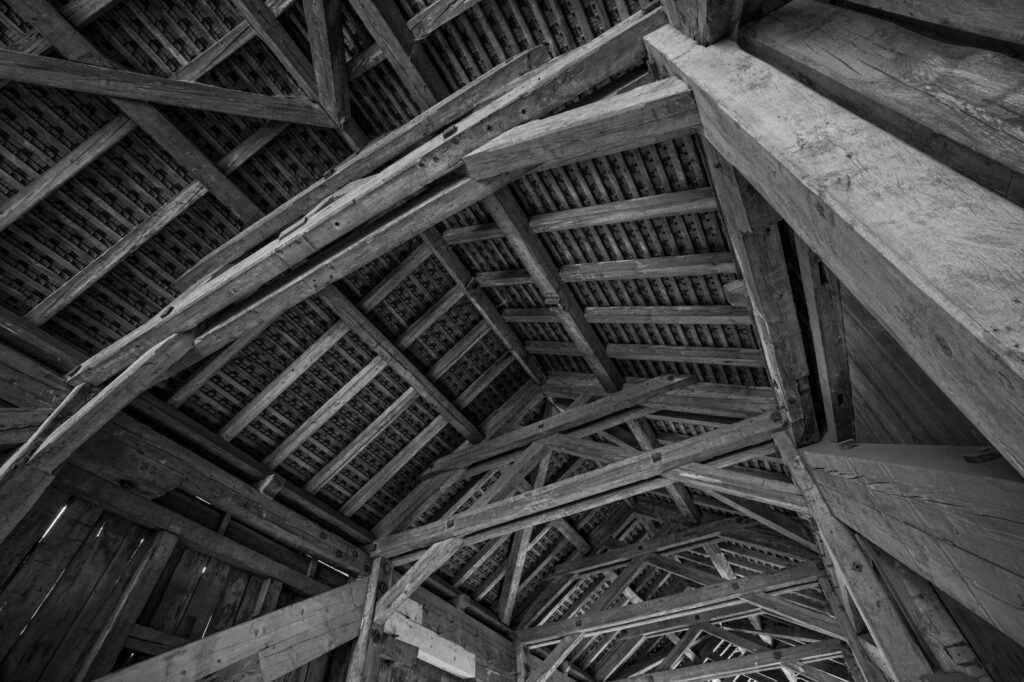 grayscale photo of wooden ceiling