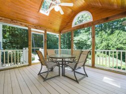 Wooden Porch in a Forest with a Garden Table and Chairs
