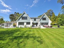 White and Gray Wooden House Near Grass Field and Trees